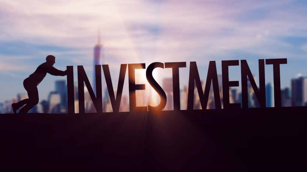 Investment - Businessman silhouette pushing thematic title