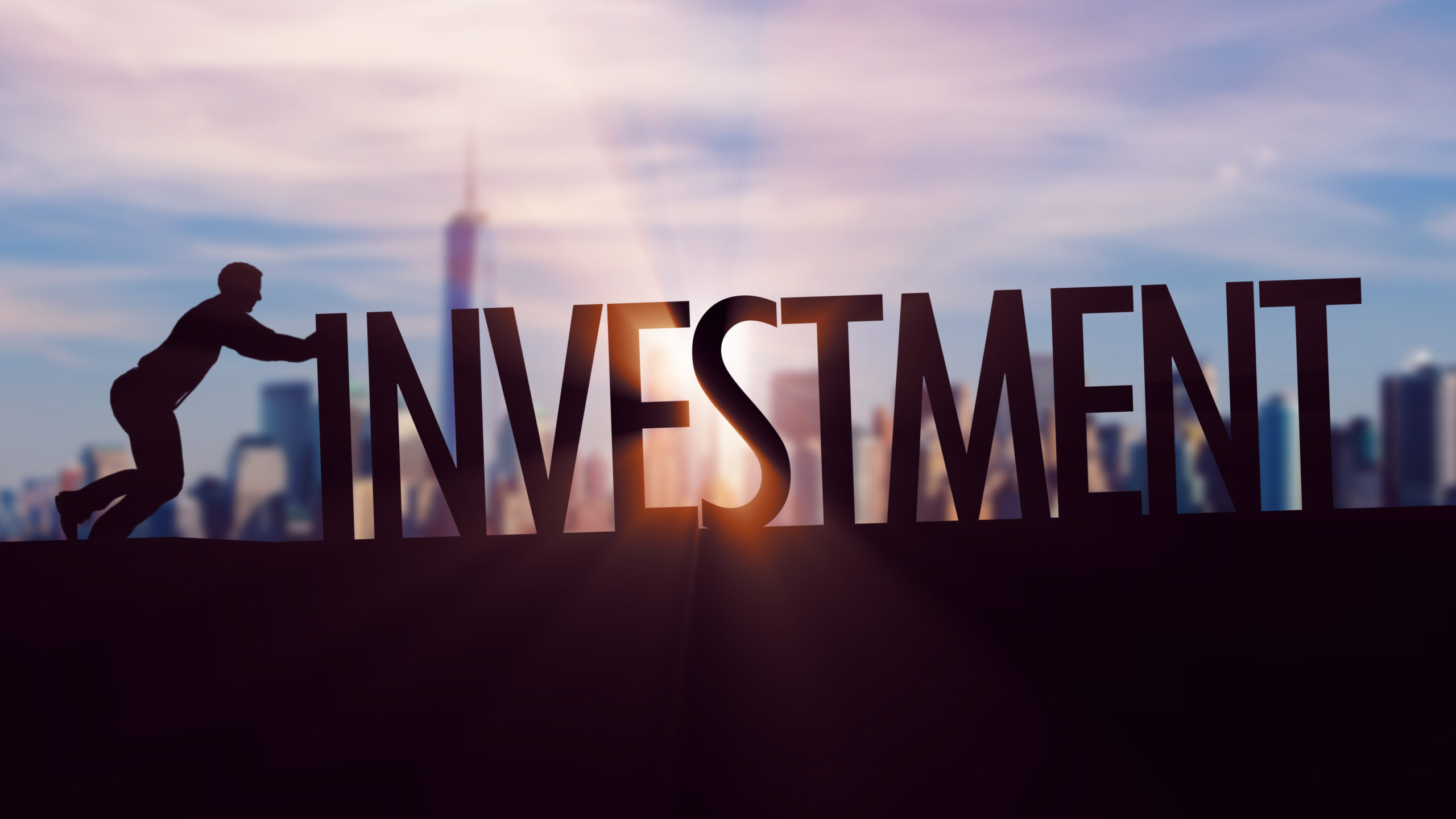 Investment - Businessman silhouette pushing thematic title